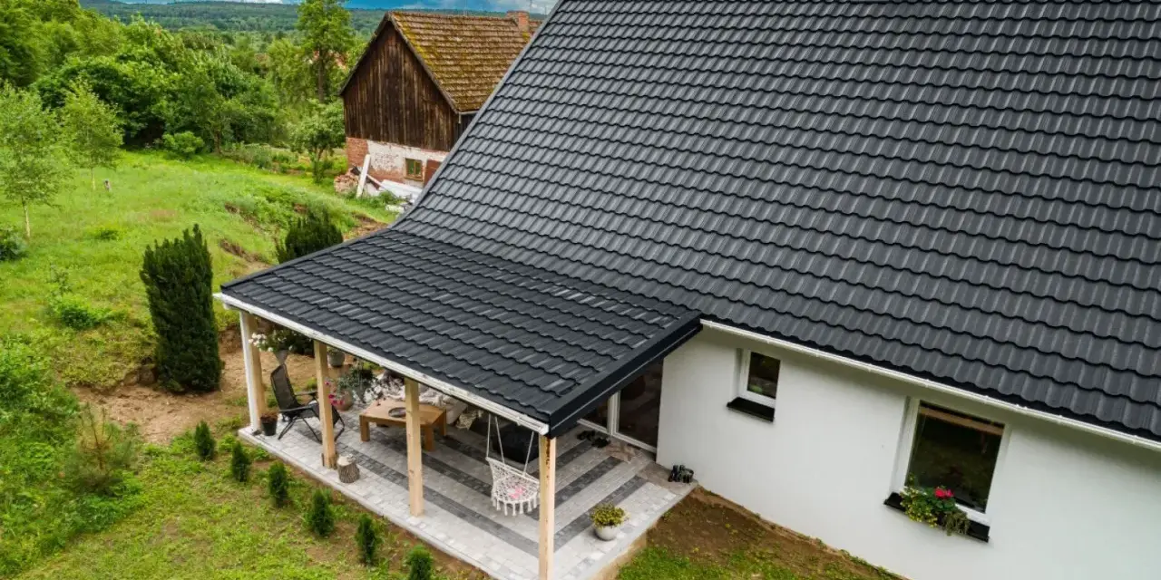 Nowy, ciemny dach z dachówki nad tarasem. Dowiedz się, jak naprawić dach z dachówki, by służył latami.