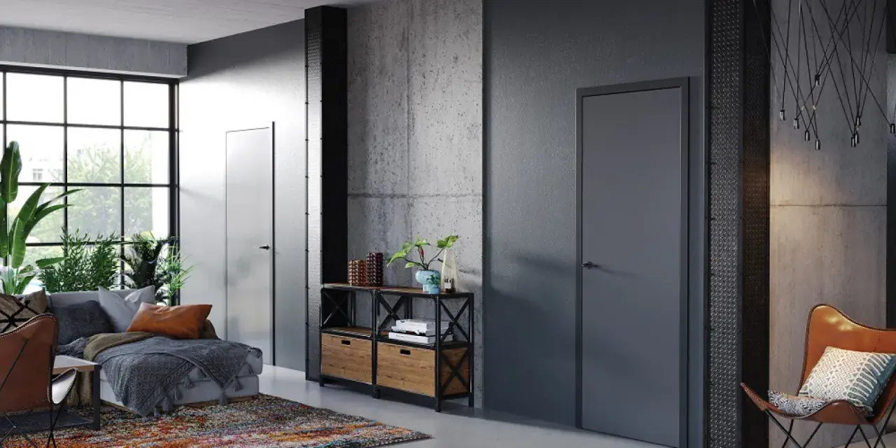 Nowoczesne wnętrze z betonowymi ścianami i drzwiami Porta System, które podkreślają elegancję przestrzeni.