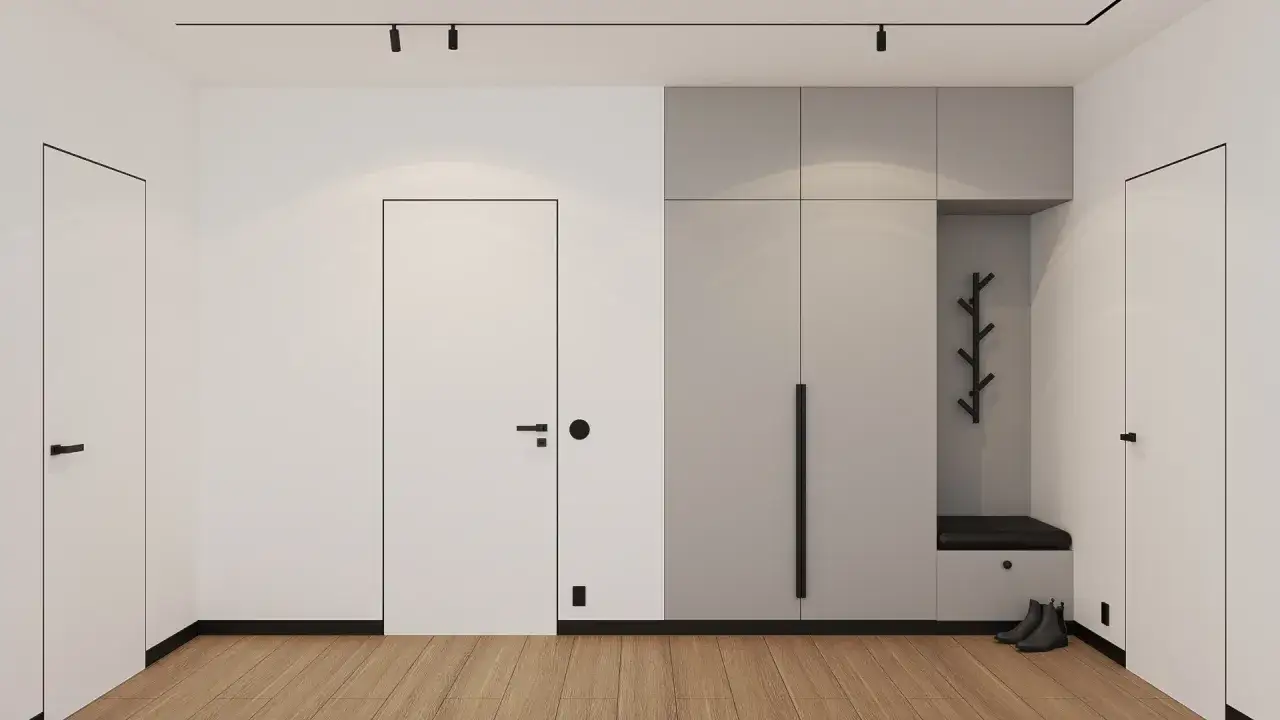 Minimalistyczne wnętrze z drzwiami z czarną ościeżnicą, nowoczesną szafą i drewnianą podłogą.