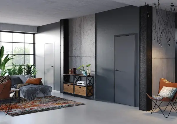 Nowoczesne wnętrze z betonowymi ścianami i drzwiami Porta System, które podkreślają elegancję przestrzeni.